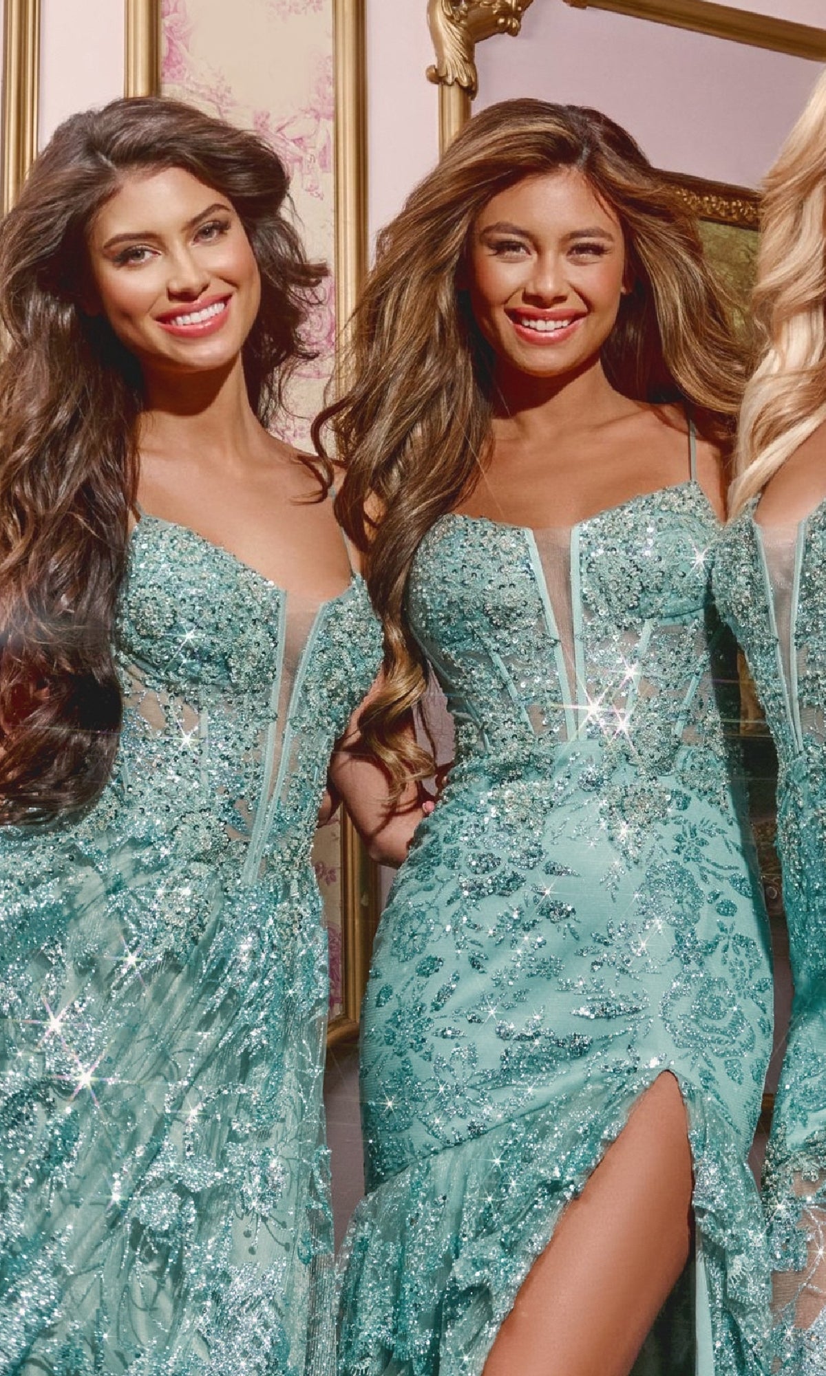 Two women in Jovani 38468 Illusion Long Sequin Prom Dresses, featuring shimmering aqua-blue sequins and high slits, stand side by side and smile in an elegantly decorated room.